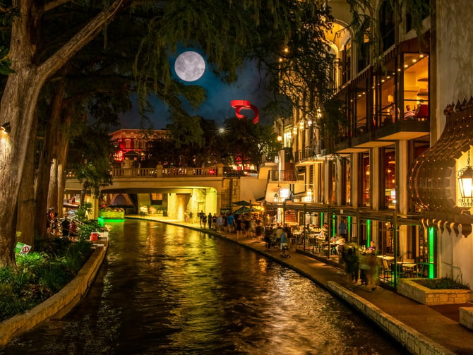 San Antonio River Walk at night with full moon