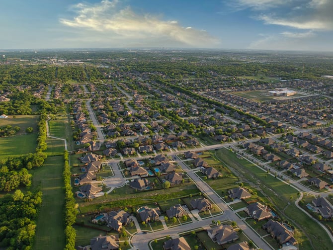 Wide aerial view of a Texas suburb at golden hour