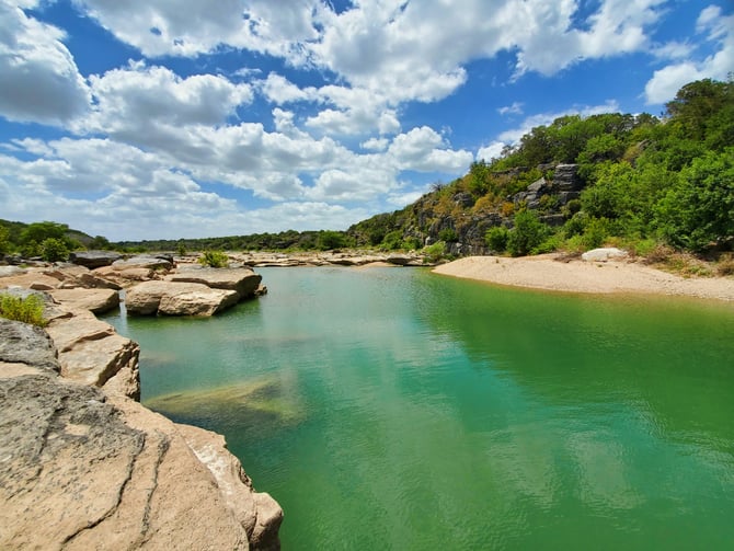 Green lake with rocky shores at Canyon Lake Texas