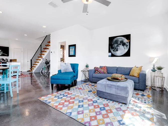 Modern open-plan condo living room with polished concrete floors